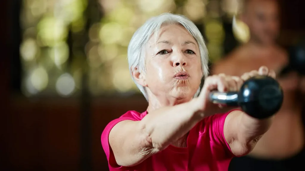 Toning Arms Without the Bulk: Is It Achievable? 1 Woman doing resistance band exercises for toned arms Port Glasgow